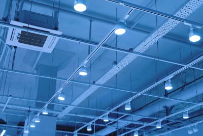 Industrial ceiling with lighting and ventilation systems.