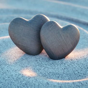 two stone hearts in the sand