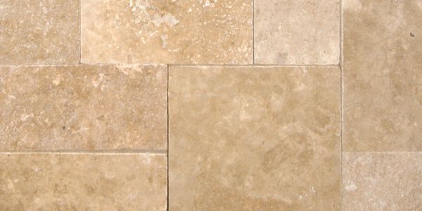 Beige natural stone tiles with varied textures and sizes.