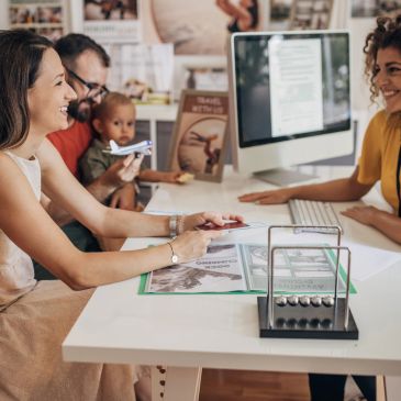 Family discussing with a consultant at a desk.