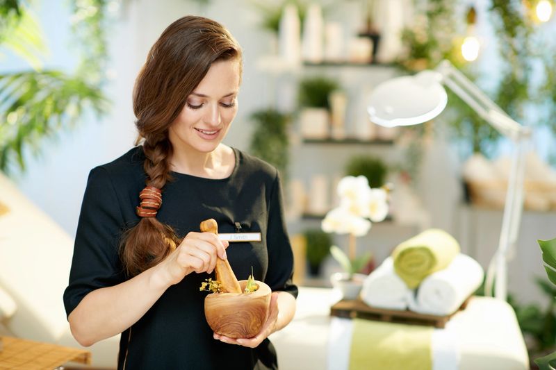 happy middle aged woman employee in modern beauty studio working.