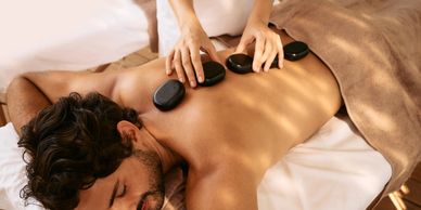 Indulge  in our signature Massage Collection, showcasing a serene massage environment with calming c