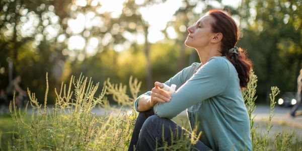 Woman enjoying a peaceful moment outdoors in nature.