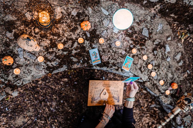 Young witch, fortune teller reads Tarot cards.