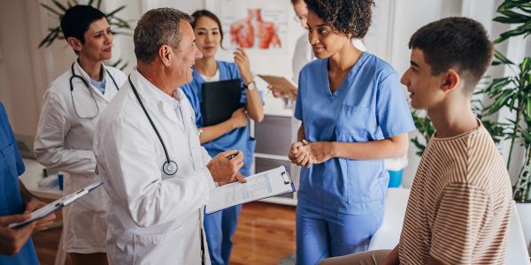 Doctors discussing with a patient in a medical office.