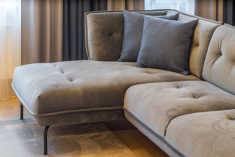 Close-up of cushions on cozy grey sofa. Modern interior of living room.