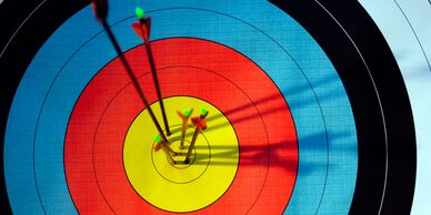 Archery arrows hitting the bullseye.