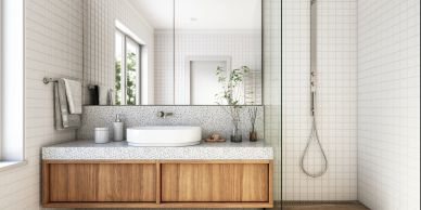 Modern bathroom with wooden vanity and glass shower.