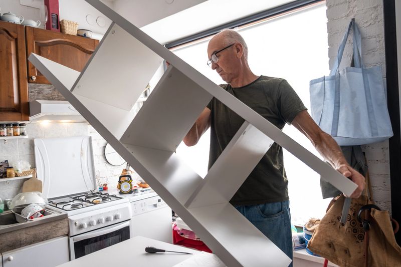 Senior man assembling new furniture