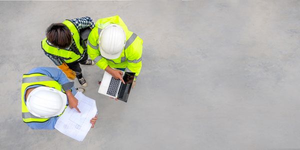Three engineers discussing plans