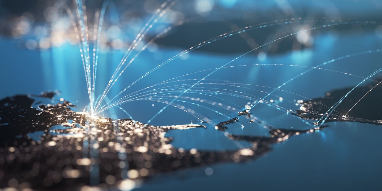 Digital map showing global network connections with glowing lines and illuminated cities.