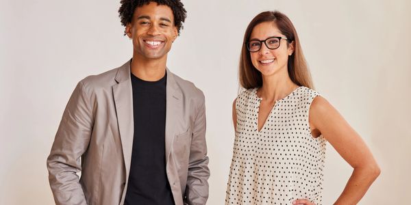 Two professionals smiling confidently at the camera.