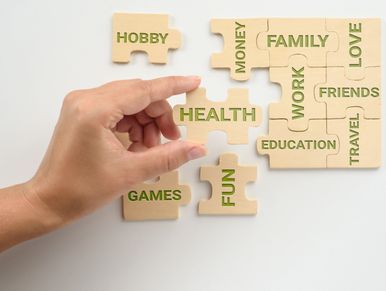 Hand placing a puzzle piece labeled 'FUN' among life aspects like health, family, and work.
