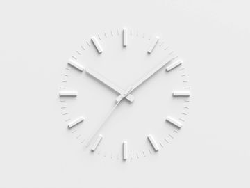 White minimalist wall clock with no numbers.