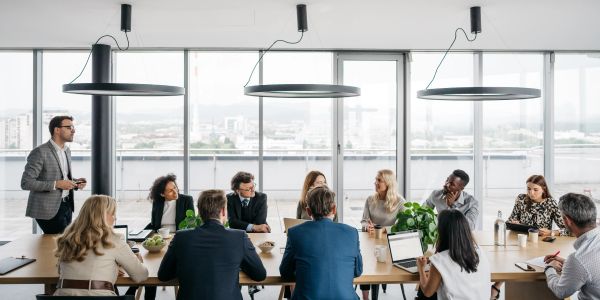 A diverse team in a business meeting around a conference table.
