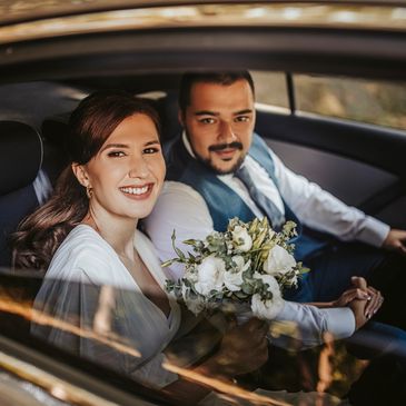newly wedded couple in their wedding car leaving for honeymoon