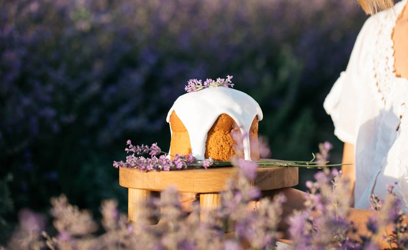 Easter cake on the wooden stand on the background of blooming lavander field.