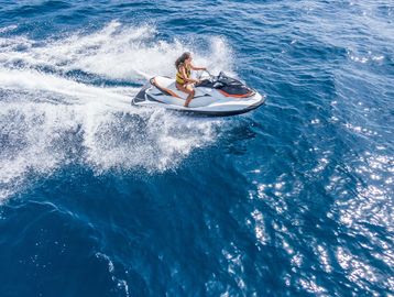Person riding a jet ski on the ocean.