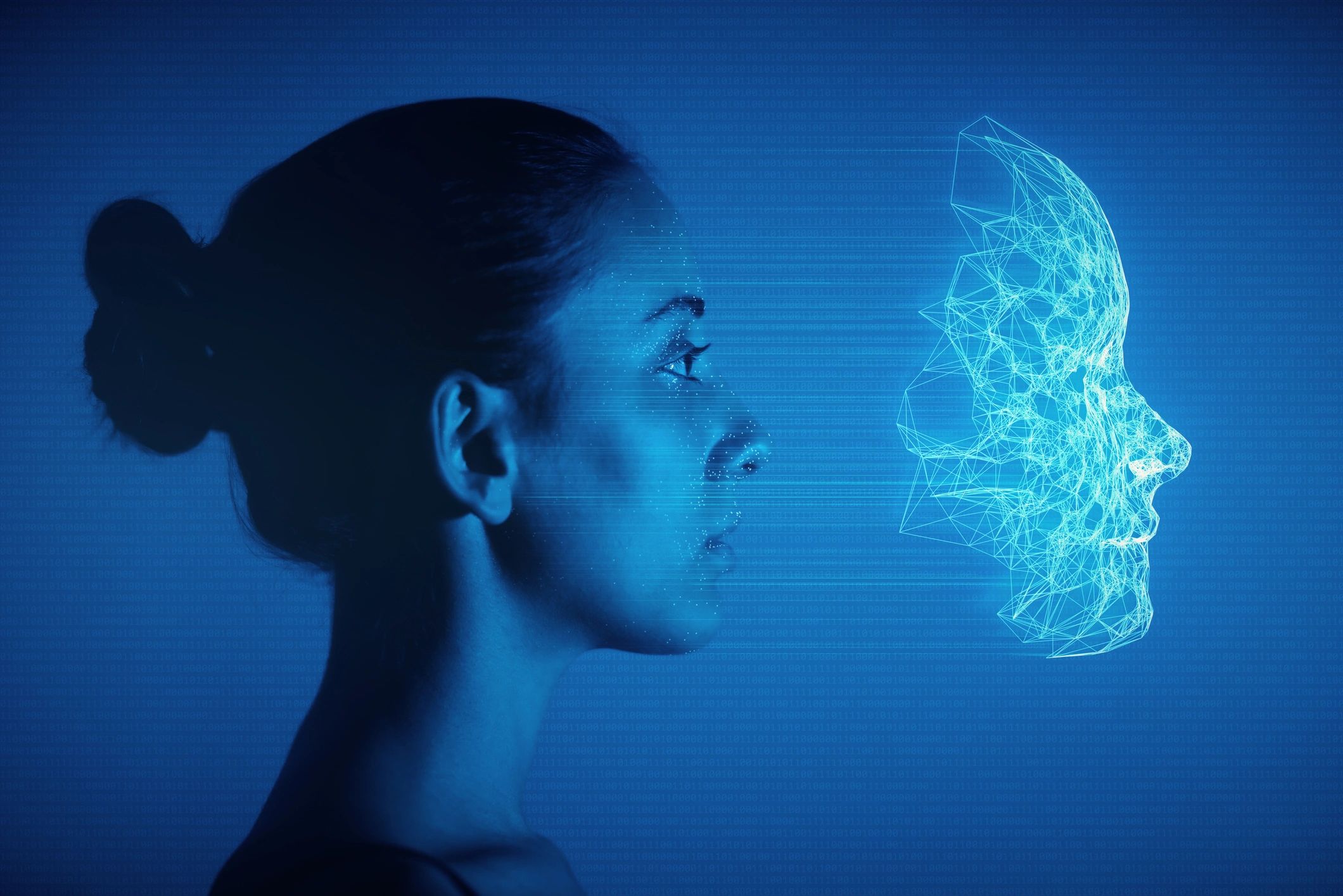 Profile of a woman with a digital wireframe face projection.