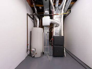 Utility room with water heater and furnace.