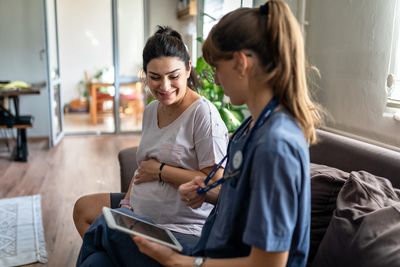 Pregnant woman meeting with healthcare provider – perinatal therapy Rockland MA.