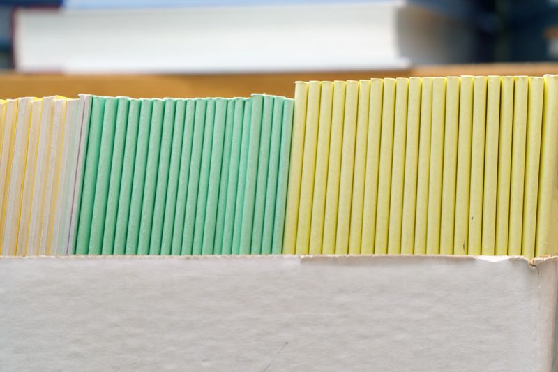 Books, brochures or notebooks on a shelf in the library