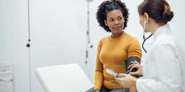 Doctor checking a patient's blood pressure.