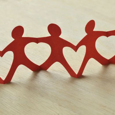 Red paper chain figures with heart shapes.