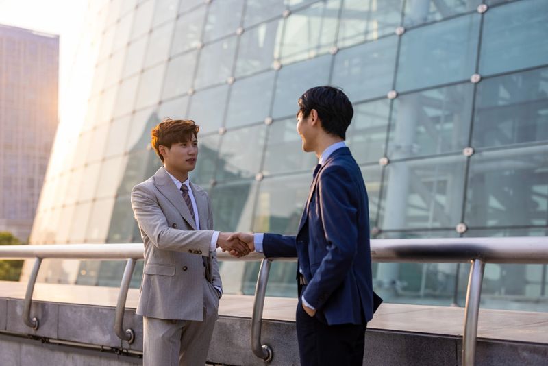 Two businessmen are shaking hands
