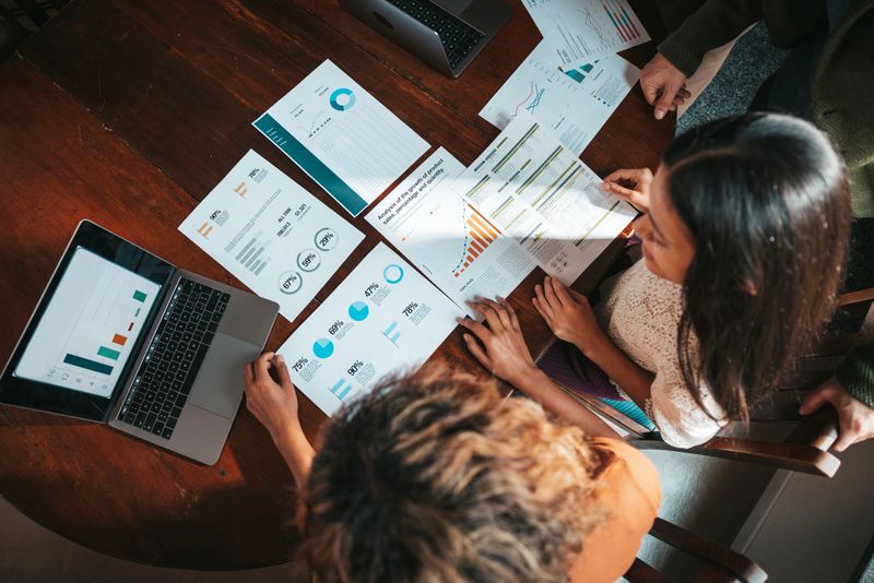 Group of millennials working in the office. Young creative team cooperating on new commitments.