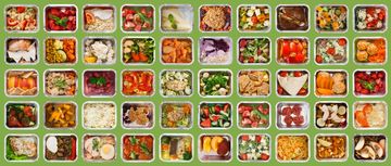 Variety of healthy meals in foil containers against green background.