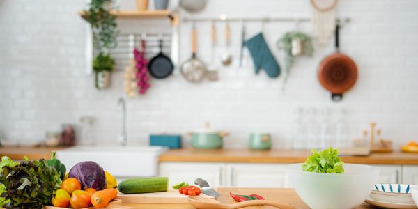 Woman happily preparing a meal in her cozy kitchen.