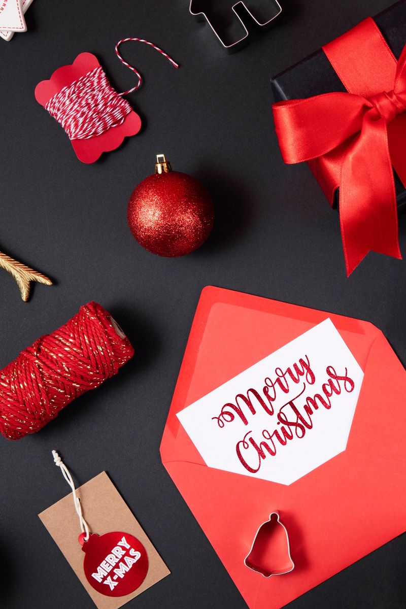 Christmas related objects and ornaments  flat lay on black background