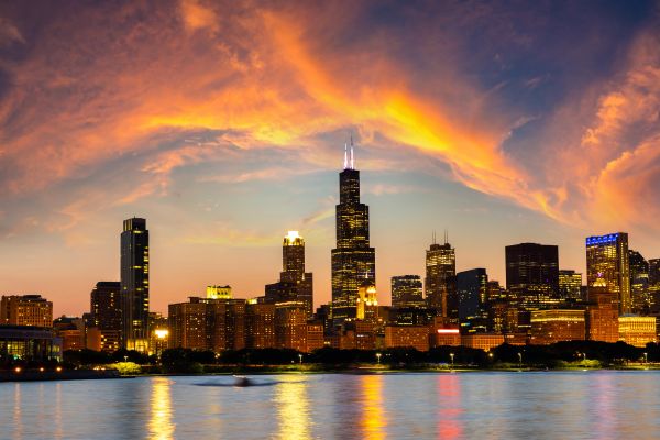 City skyline at sunset with vibrant clouds.