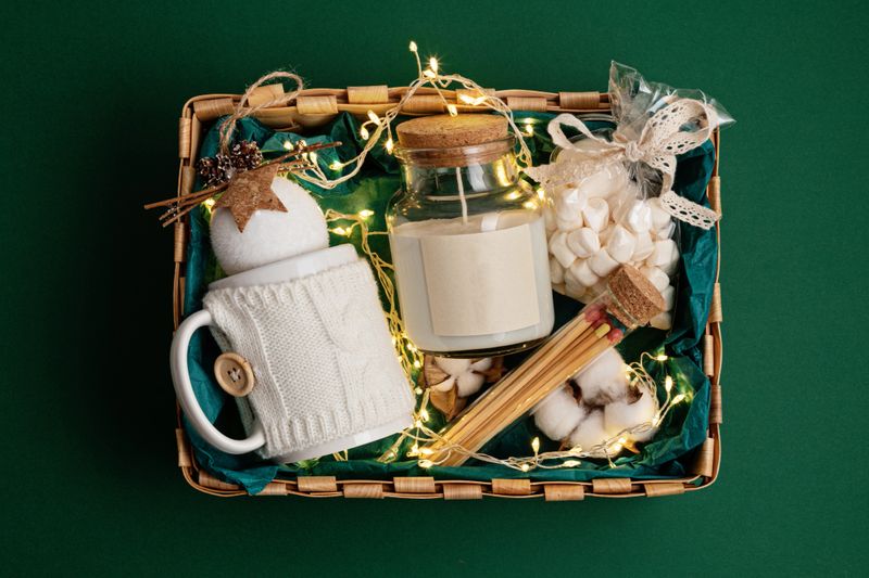 Refined Christmas gift basket for romantic holidays with aroma candle and matches. Corporate or personal present for family and friends.