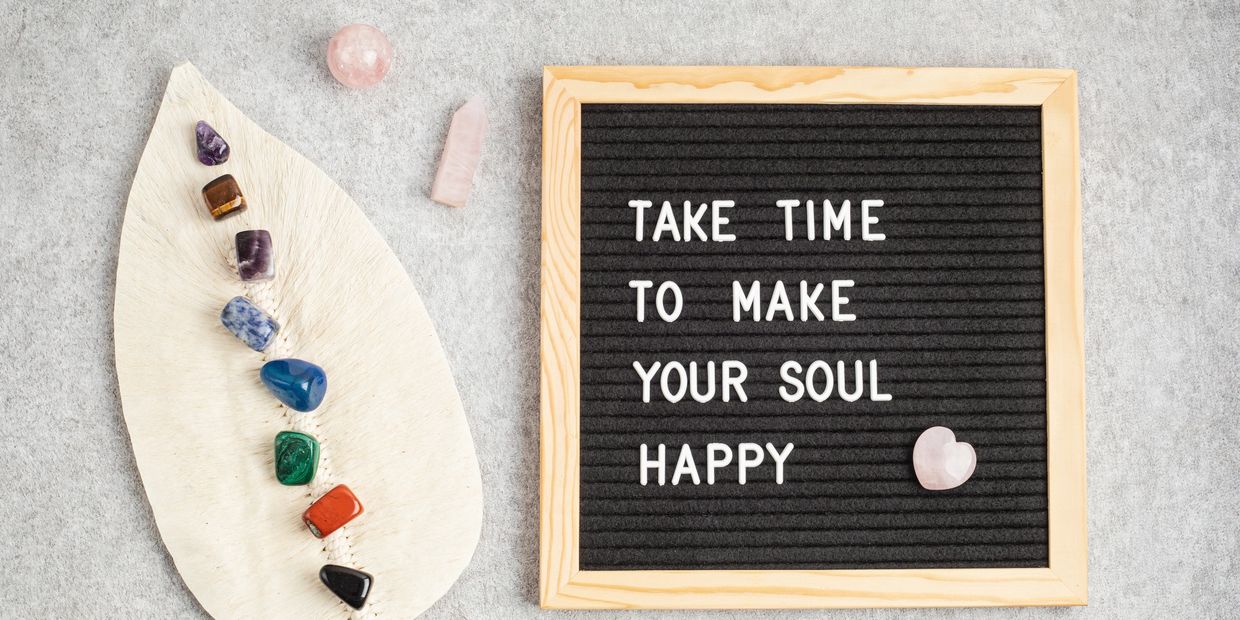 A leaf with crystals. Board quoting " take time to make your soul happy"