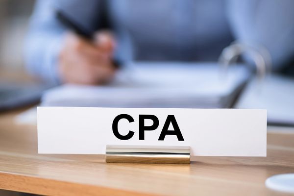 CPA at desk with nameplate, providing IRS tax defense and audit representation services