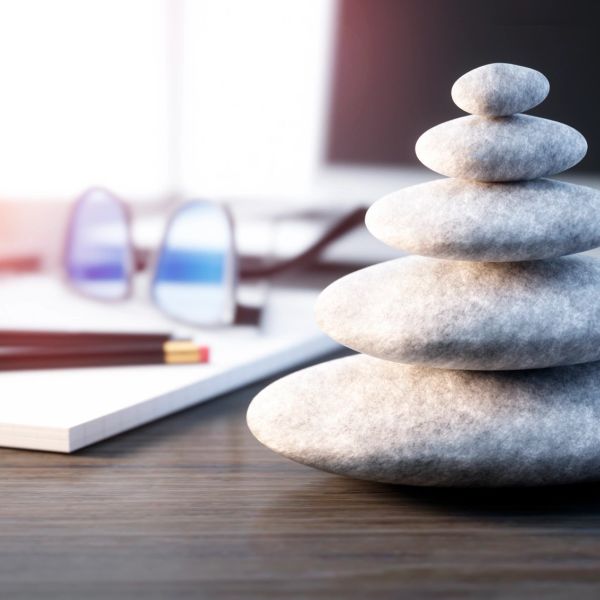 Stacked stones symbolizing balance on a desk.