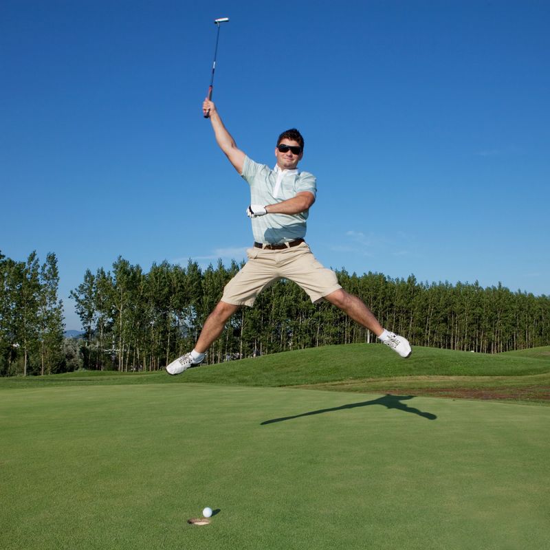 Happy golfer jumping before last put