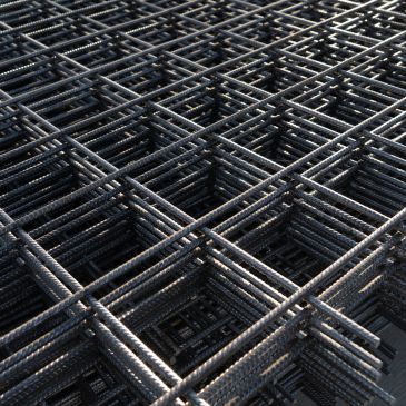 Stacked steel reinforcement bars forming a grid pattern.