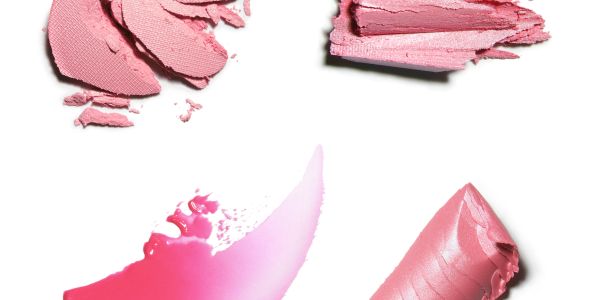 Various shades of pink lipstick smudges on white background.