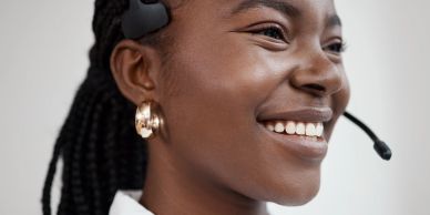 Smiling woman with headset.