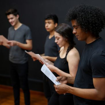 Actors reading scripts.