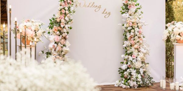 Wedding day floral arch setup