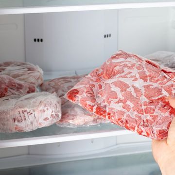 Frozen meat slices inside a freezer.