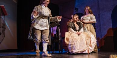 Actors performing a historical play on stage.