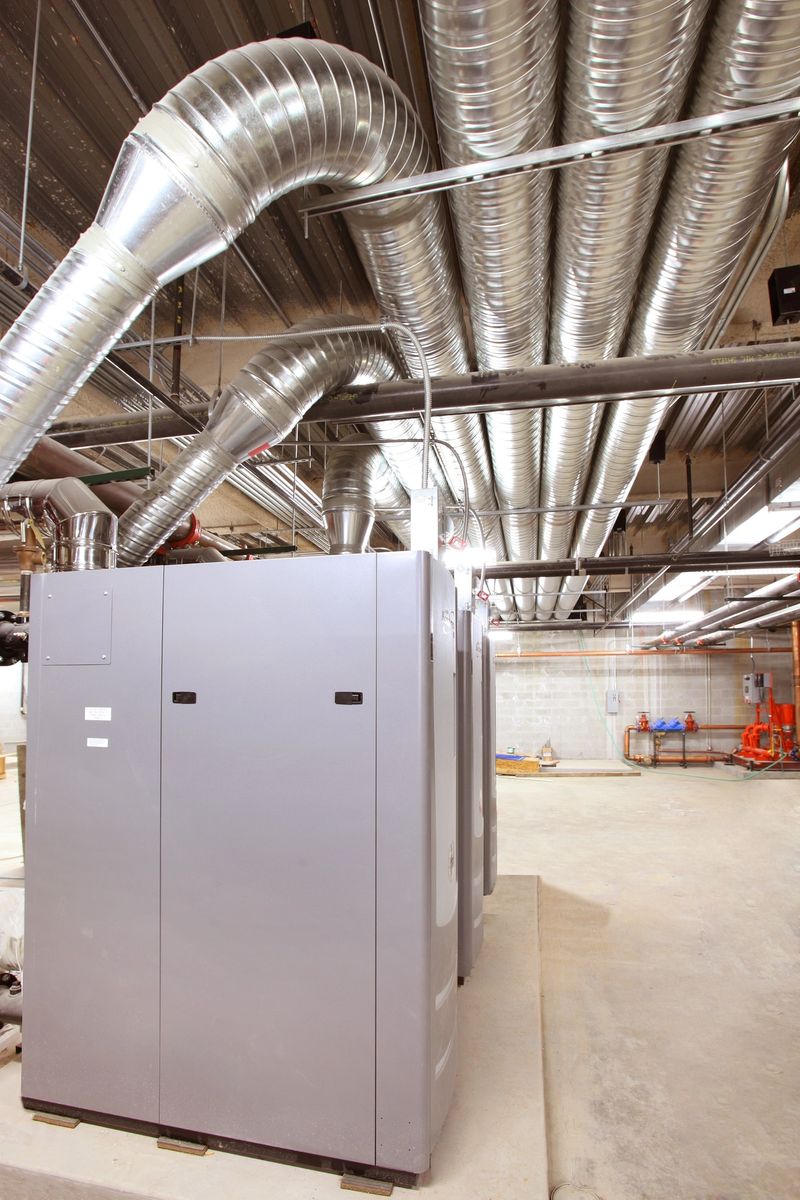 Installing a high efficiency HVAC system and duct work in a large modern office building.