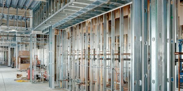 Interior view of a building under construction with metal framing.
