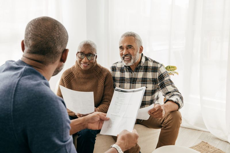 African American couple talking to health insurance broker