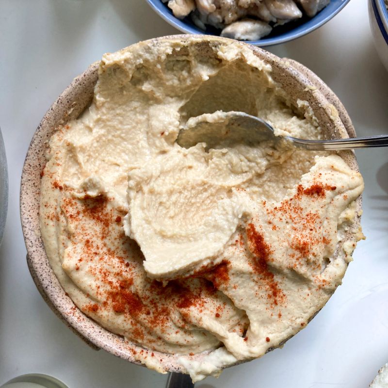High angle view of hummus made with chick-pea and paprika at home and ready to eat.